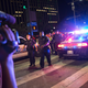 Bystanders stand near police barricades following the sniper shooting in Dallas on July 7, 2016.
LAURA BUCKMAN/AFP/Getty Images
